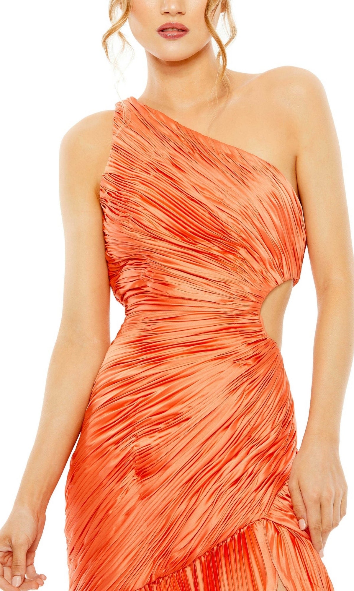 A woman models the Long Formal Dress 49683 by Mac Duggal, featuring a pleated orange one-shoulder design with a side cutout and an elegant skirt, standing before a white background.